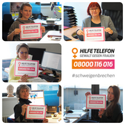 5 Mitarbeitende von Frauenhauskoordinierung halten je ein Schild "Hilfetelefon Gewalt gegen Frauen: 08000116016 #SchweigenBrechen"